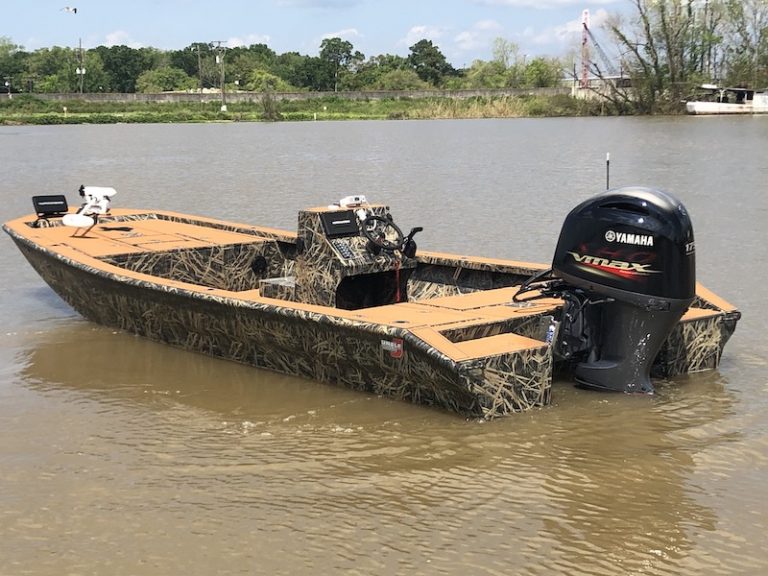 Marsh grass camo boat with a tan deck, center console and Yamaha VMAX outboard