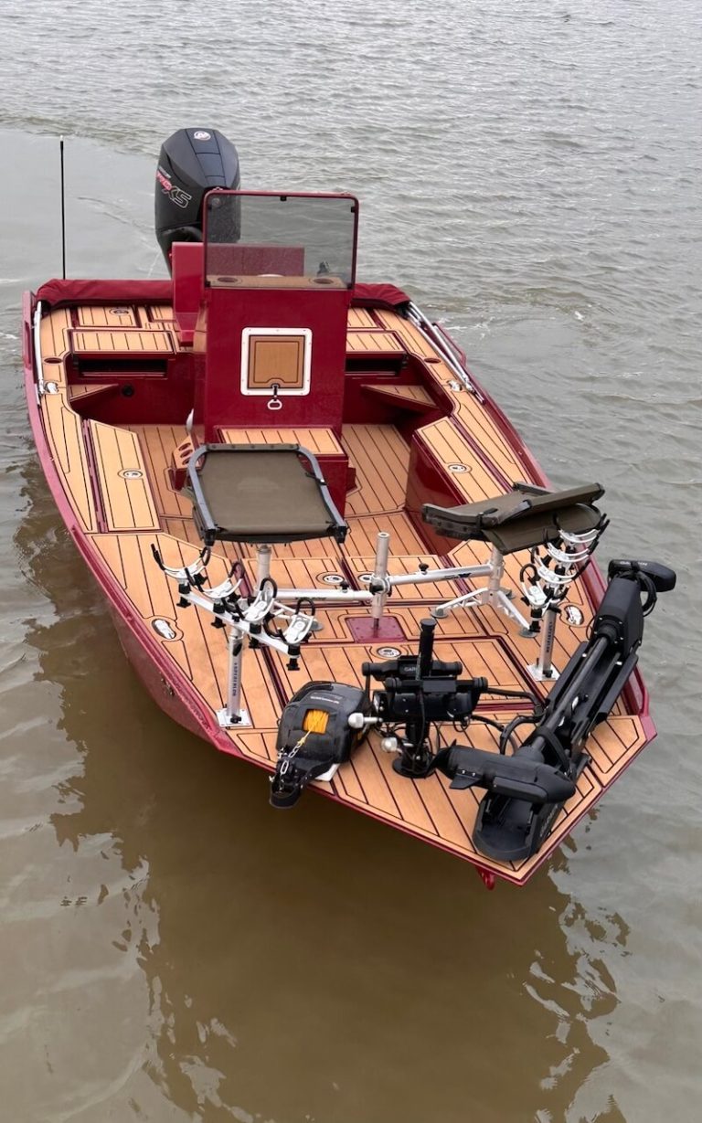 Red bay boat with wood-look decking and a center console, seen from above