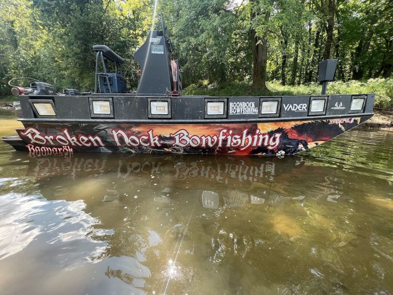 Broken Nock Bowfishing boat on the water with a row of lights along the side