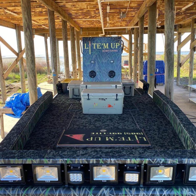 Lite'm Up Bowfishing boat deck under a boathouse, with a cooler and a row of bow lights