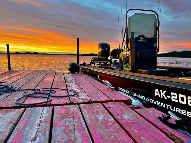 Matsu Jolly Roger Fishing guide boat at a wooden dock at sunset