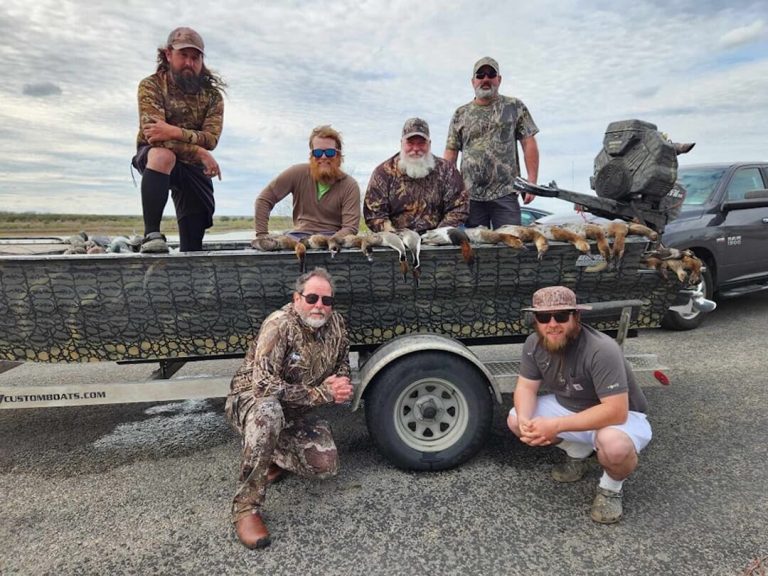 SoTex Outdoors hunters with their ducks on a camo Uncle J boat on its trailer