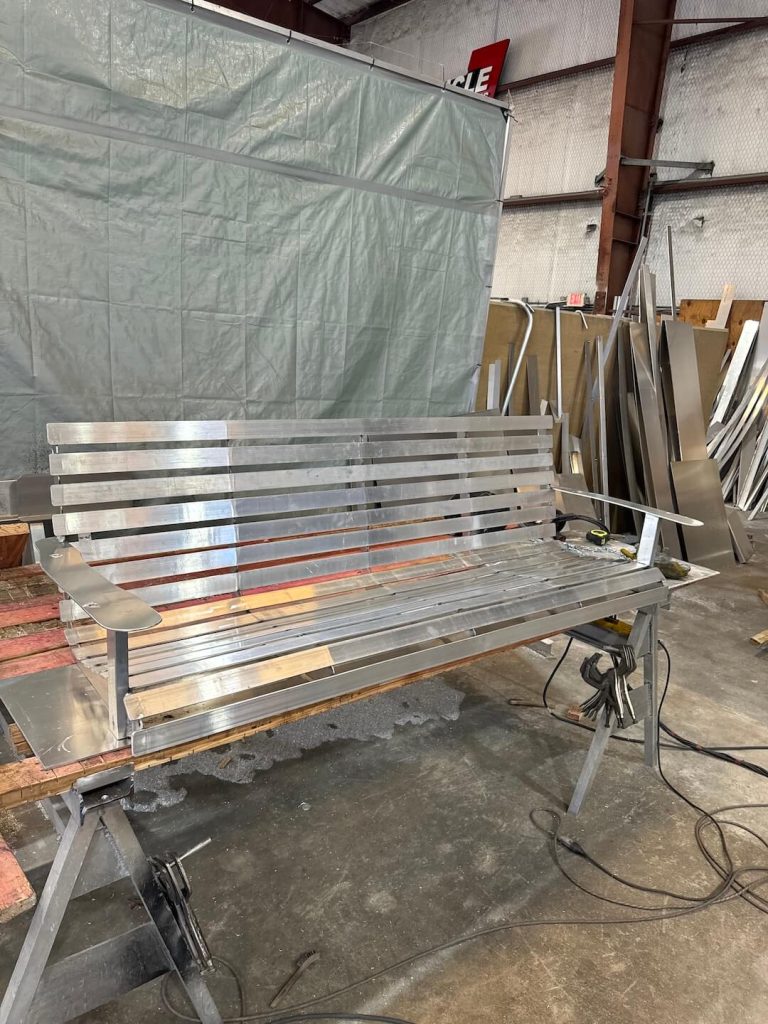 Aluminum bench swing with a slatted seat and back