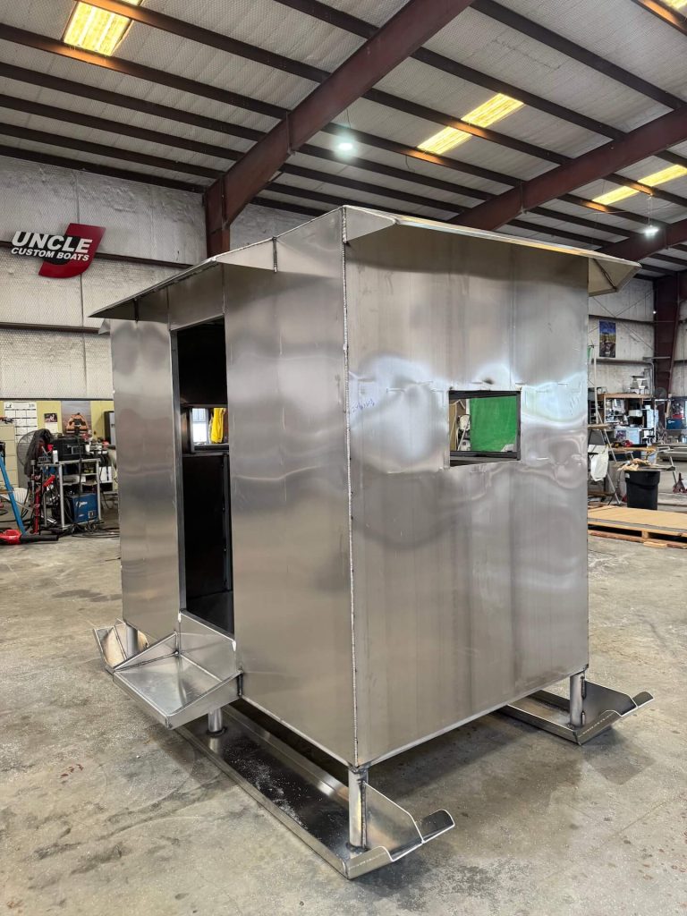Aluminum enclosure on skids with an open doorway and a side window