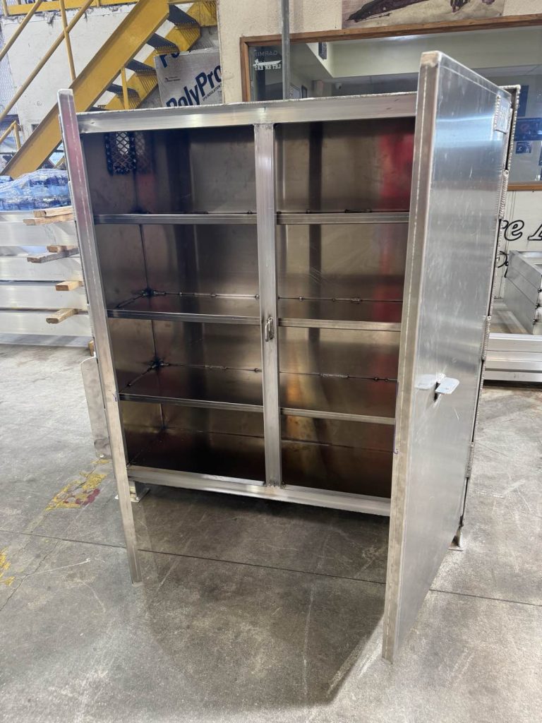 Aluminum storage cabinet with its double doors open, showing the shelves