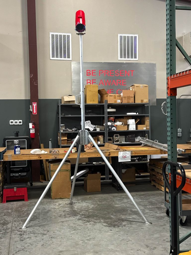 Aluminum tripod light stand with a red beacon, front view